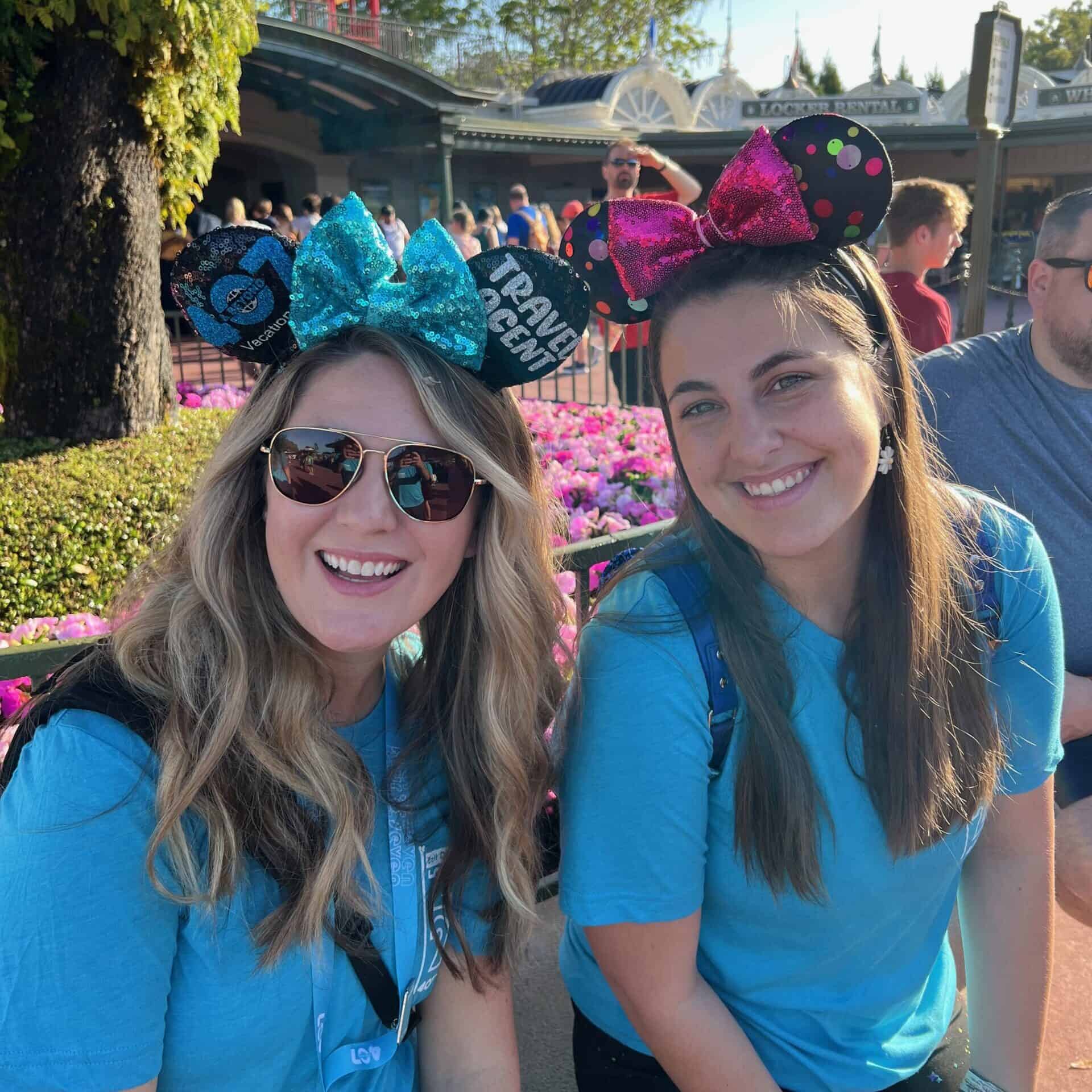 Colorful Disney-themed headbands worn by smiling women at the workplace event.