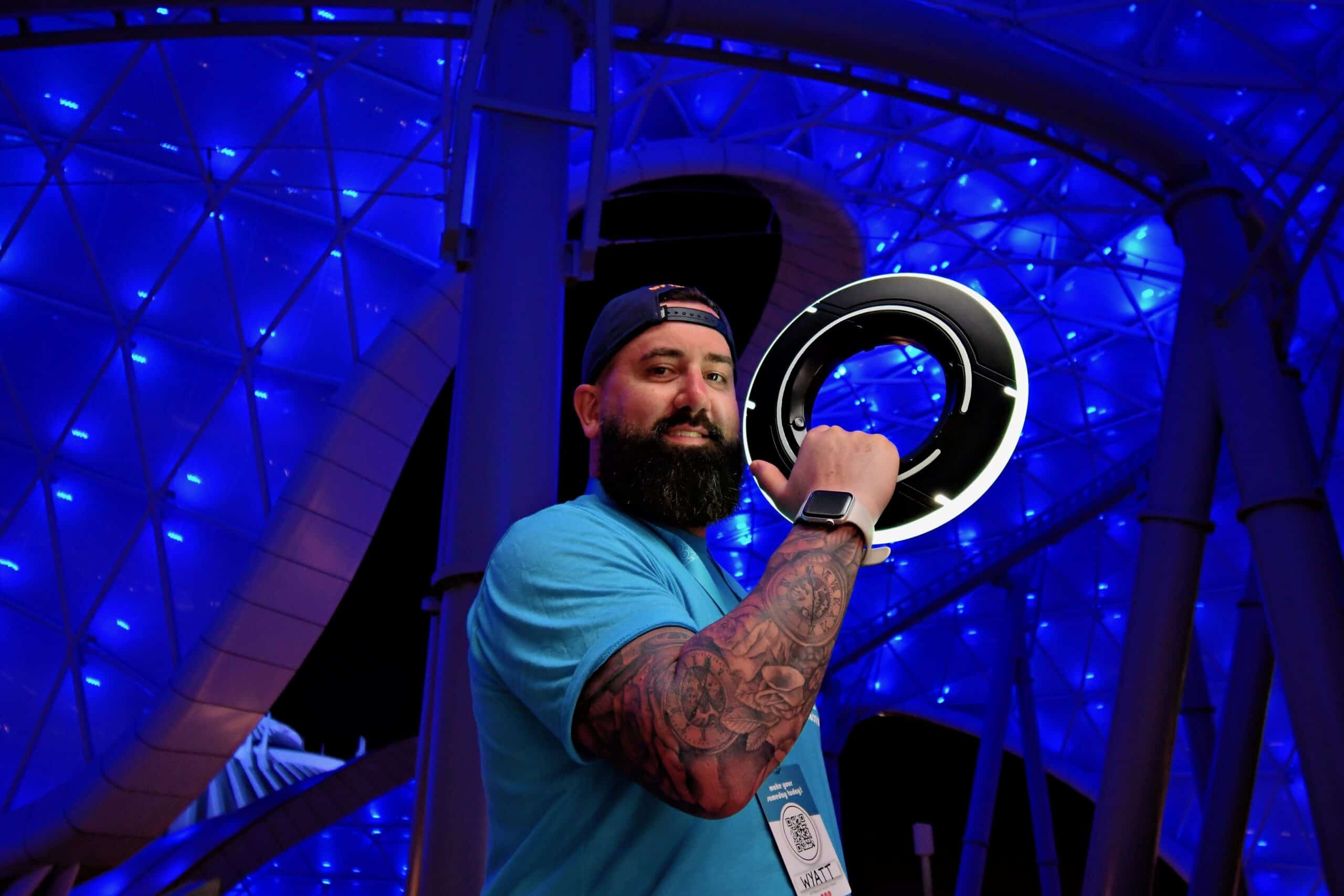 Innovative tech professional at 407&Beyond work event with futuristic lighting environment.