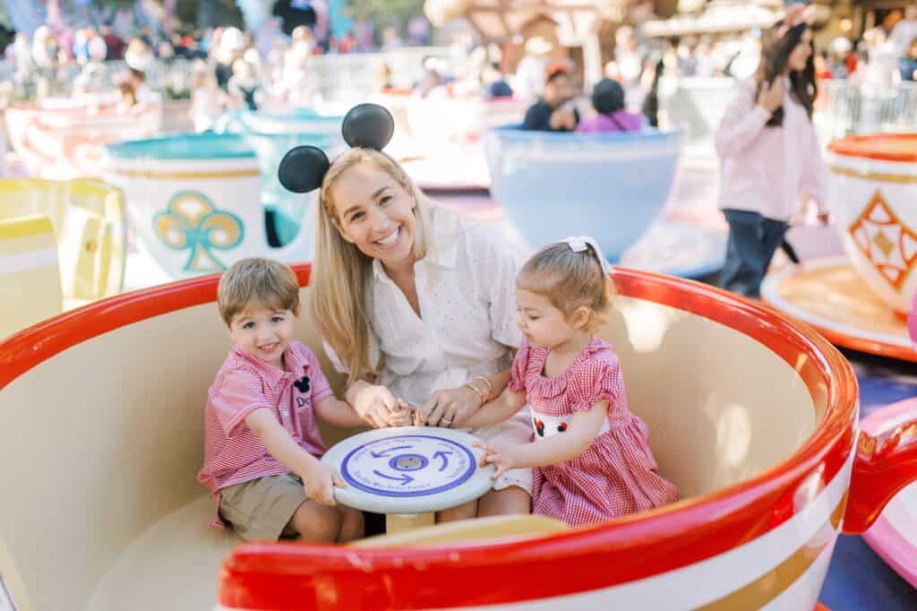 Whimsical teacup ride at 407&Beyond amusement park with happy children and family fun.
