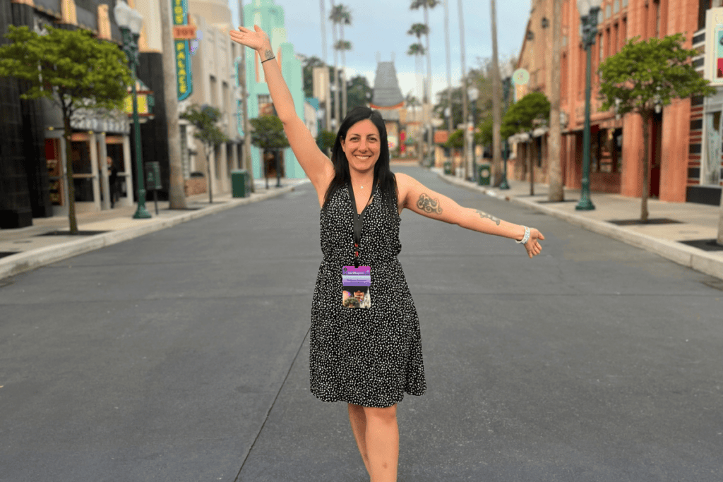 Happy woman celebrating achievement on an empty city street.