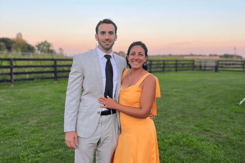 Happy couple at outdoor event celebrating achievement and perseverance.